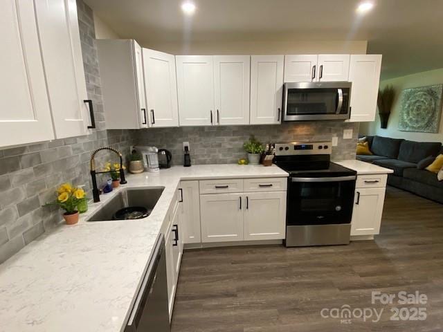 9800 Feldbank Dr, Charlotte, NC 28216 - kitchen featuring stainless steel appliances, dark wood finished floors, and white cabinets