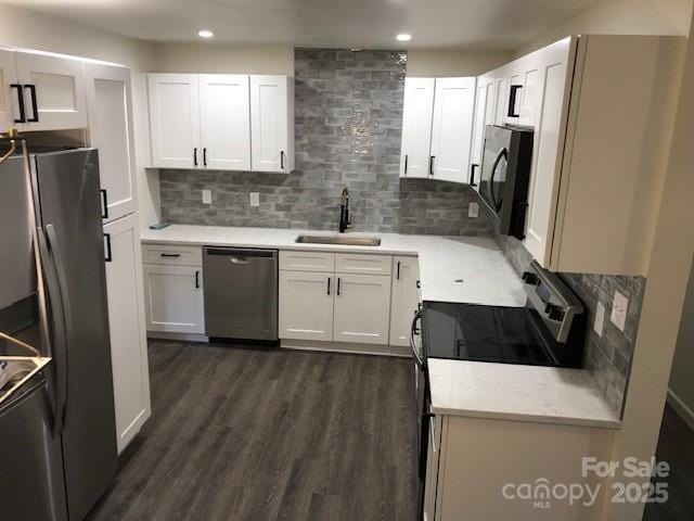 9800 Feldbank Dr, Charlotte, NC 28216 - kitchen with stainless steel appliances, white cabinets, decorative backsplash, and recessed lighting