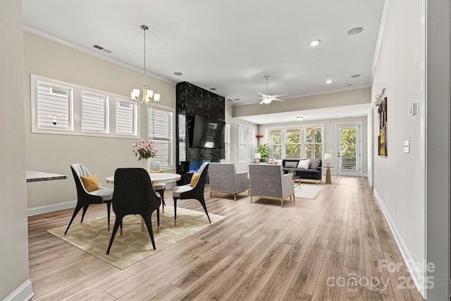 7315 Surprise Ct, Charlotte, NC 28215 - dining space with crown molding, light wood-style floors, ceiling fan, a chandelier, and recessed lighting