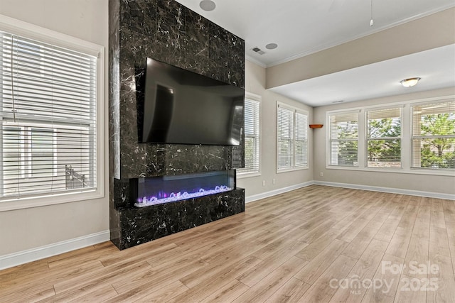 7315 Surprise Ct, Charlotte, NC 28215 - unfurnished living room featuring light wood-style flooring, crown molding, and a fireplace