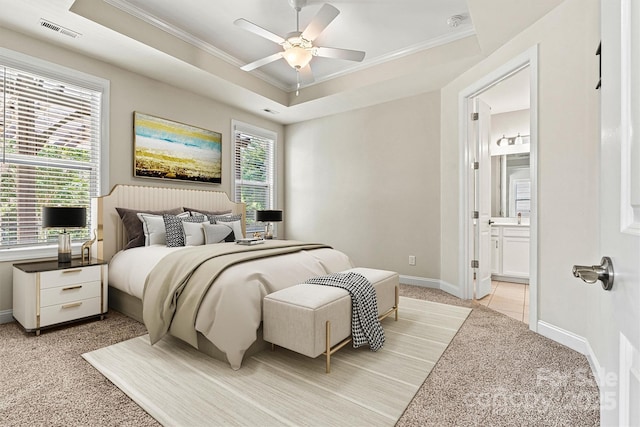 7315 Surprise Ct, Charlotte, NC 28215 - bedroom with light carpet, ornamental molding, ensuite bath, ceiling fan, and a tray ceiling