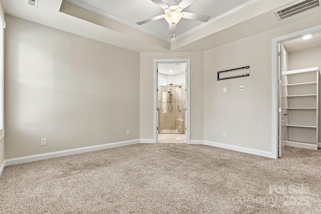 7315 Surprise Ct, Charlotte, NC 28215 - unfurnished bedroom featuring ornamental molding, carpet, a spacious closet, a raised ceiling, and ensuite bath