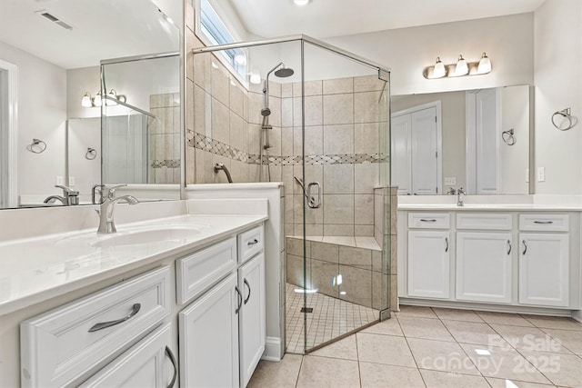7315 Surprise Ct, Charlotte, NC 28215 - full bath with two vanities, a stall shower, and tile patterned floors