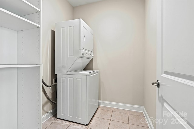 7315 Surprise Ct, Charlotte, NC 28215 - laundry area with stacked washer / drying machine and light tile patterned floors