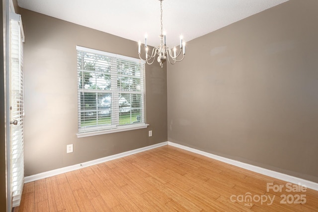 10613 Prairie Ridge Ln, Charlotte, NC 28213 - unfurnished room featuring a chandelier and light wood-style floors