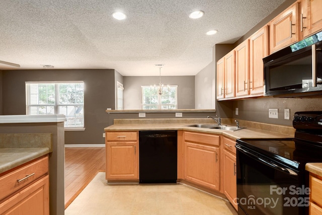 10613 Prairie Ridge Ln, Charlotte, NC 28213 - kitchen with black appliances, a textured ceiling, a peninsula, a chandelier, and recessed lighting