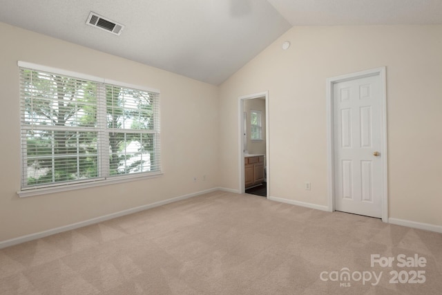 10613 Prairie Ridge Ln, Charlotte, NC 28213 - unfurnished bedroom with carpet flooring, vaulted ceiling, and connected bathroom