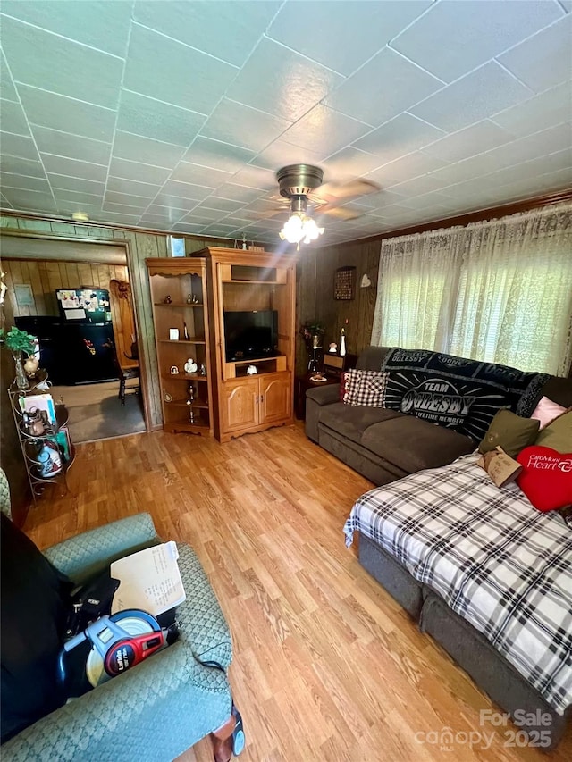 302 Margarette Ave, Belmont, NC 28012 - living area with light wood-type flooring, a ceiling fan, and wood walls