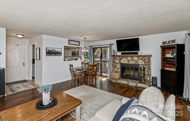 107 Cedar Forest Trl Unit 107, Asheville, NC 28803 - living area with wood finished floors, a textured ceiling, and a stone fireplace