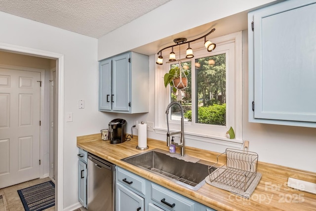 107 Cedar Forest Trl Unit 107, Asheville, NC 28803 - kitchen featuring dishwasher, blue cabinetry, and a textured ceiling