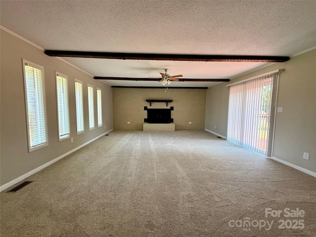 206 College Ave, Shelby, NC 28152 - unfurnished living room with a textured ceiling, ceiling fan, a brick fireplace, beamed ceiling, and carpet floors