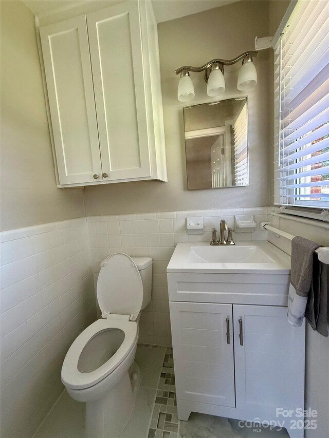 206 College Ave, Shelby, NC 28152 - bathroom featuring vanity, a wainscoted wall, and tile walls