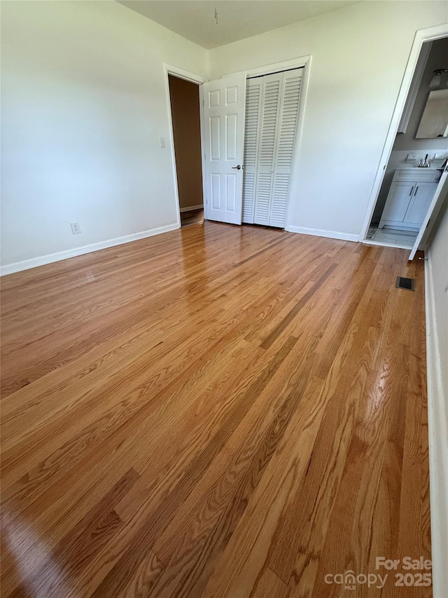 206 College Ave, Shelby, NC 28152 - unfurnished bedroom featuring wood finished floors, a closet, and connected bathroom