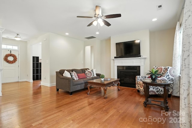 8275 Normandy Rd, Denver, NC 28037 - living area featuring a ceiling fan, light wood-type flooring, a fireplace with flush hearth, and recessed lighting