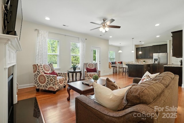 8275 Normandy Rd, Denver, NC 28037 - living room featuring a fireplace, wood finished floors, ceiling fan, and recessed lighting