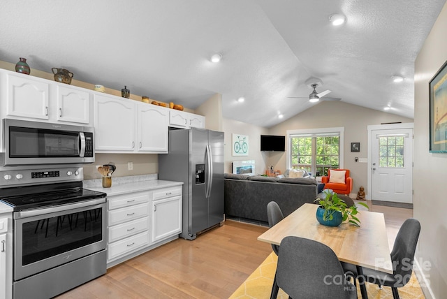 12 Buckshot Ridge Dr, Asheville, NC 28804 - kitchen with stainless steel appliances, white cabinetry, a ceiling fan, light countertops, and vaulted ceiling