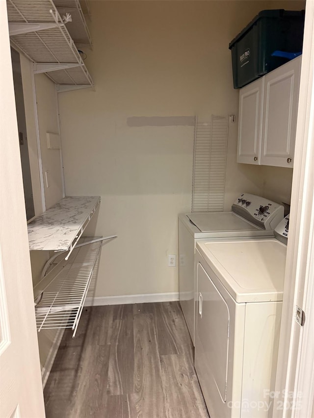 6112 Creft Cir, Indian Trail, NC 28079 - washroom featuring wood finished floors, washer and clothes dryer, and cabinet space