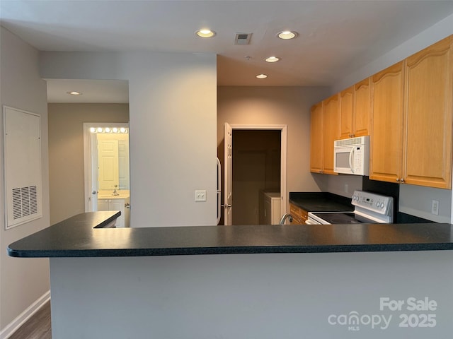 6112 Creft Cir, Indian Trail, NC 28079 - kitchen with white appliances, separate washer and dryer, dark countertops, recessed lighting, and dark wood finished floors