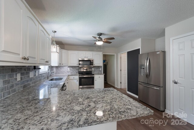 1782 Oakdale Rd, Rock Hill, SC 29730 - kitchen featuring appliances with stainless steel finishes, a ceiling fan, light stone countertops, white cabinetry, and tasteful backsplash
