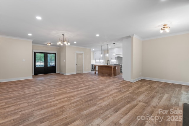 510 State Rd, China Grove, NC 28023 - unfurnished living room featuring recessed lighting, crown molding, light wood-type flooring, and a chandelier
