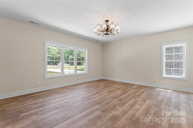 510 State Rd, China Grove, NC 28023 - spare room with a chandelier, healthy amount of natural light, and wood finished floors