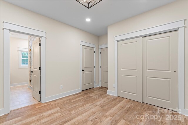 510 State Rd, China Grove, NC 28023 - unfurnished bedroom featuring light wood-style floors, recessed lighting, and connected bathroom