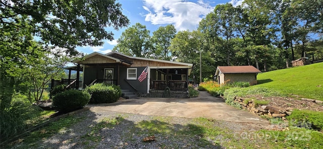 414 Pine Cove Rd, Old Fort, NC 28762 - view of front of property featuring covered porch, a front yard, and gravel driveway