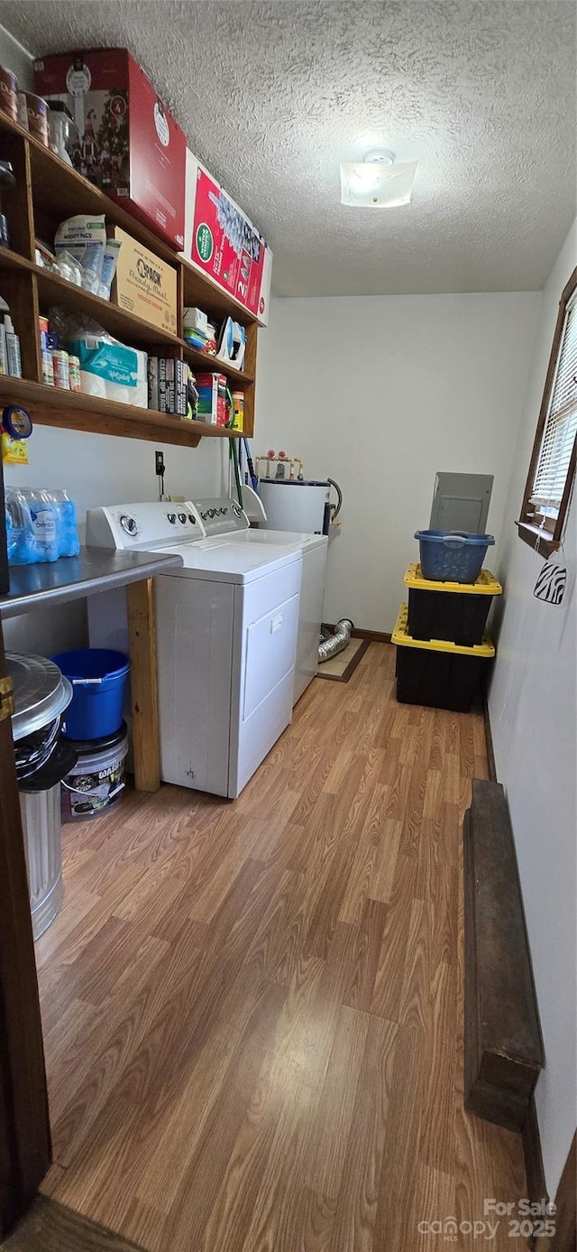 414 Pine Cove Rd, Old Fort, NC 28762 - laundry area featuring washer and dryer, light wood-style floors, and a textured ceiling