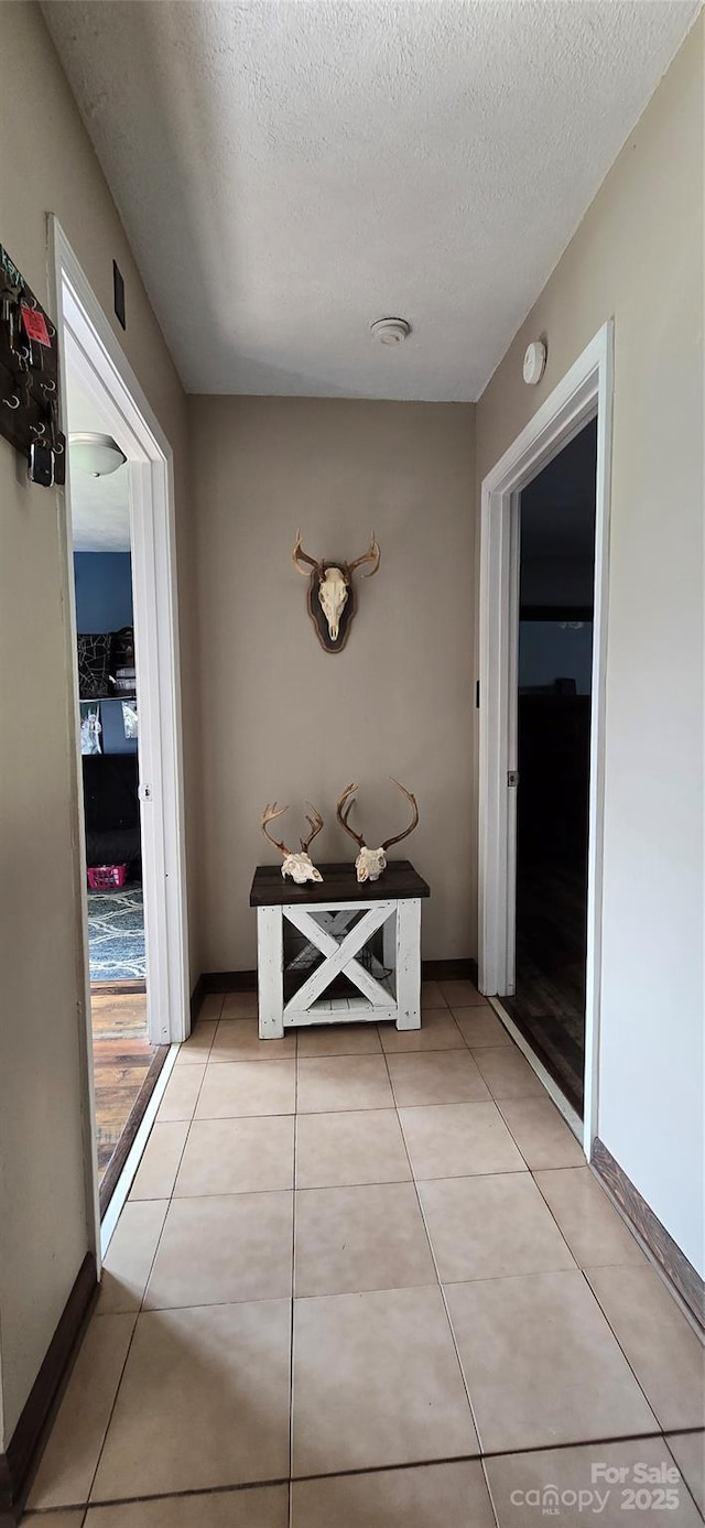 414 Pine Cove Rd, Old Fort, NC 28762 - hall with a textured ceiling and light tile patterned floors