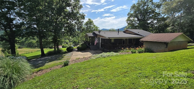 414 Pine Cove Rd, Old Fort, NC 28762 - rear view of house with a yard and a sunroom