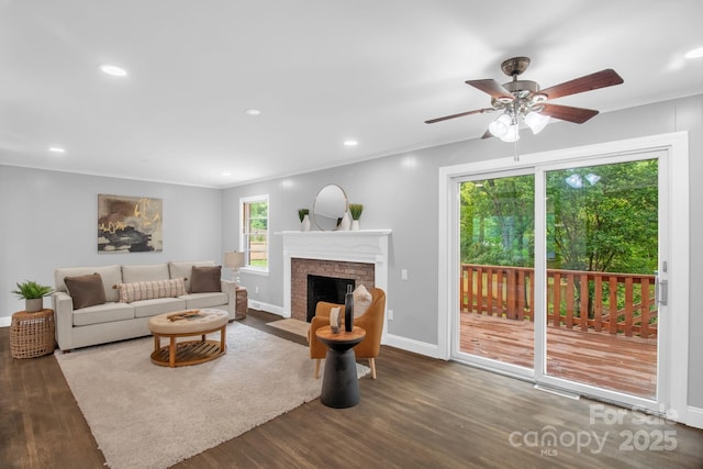 1623 Lumarka Dr, Charlotte, NC 28212 - living area featuring wood finished floors, ceiling fan, a brick fireplace, crown molding, and recessed lighting