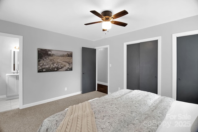 1623 Lumarka Dr, Charlotte, NC 28212 - bedroom with multiple closets, connected bathroom, ceiling fan, and carpet flooring