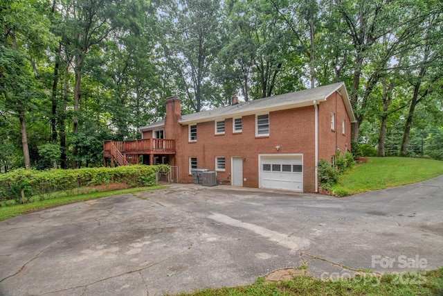 1623 Lumarka Dr, Charlotte, NC 28212 - view of front of property with a chimney, a garage, brick siding, asphalt driveway, and a deck