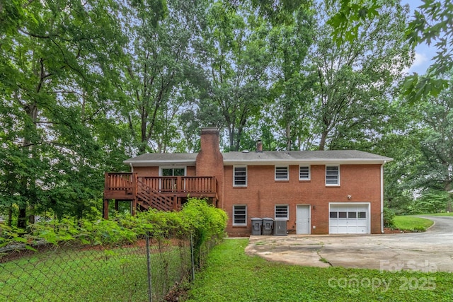 1623 Lumarka Dr, Charlotte, NC 28212 - rear view of property featuring driveway, an attached garage, a wooden deck, a chimney, and brick siding