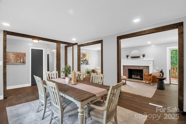 1623 Lumarka Dr, Charlotte, NC 28212 - dining room featuring wood finished floors, a fireplace, and recessed lighting