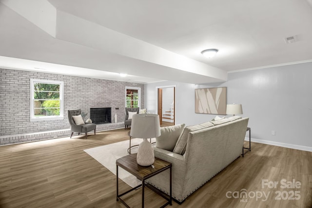 1623 Lumarka Dr, Charlotte, NC 28212 - living room with brick wall, wood finished floors, and a brick fireplace