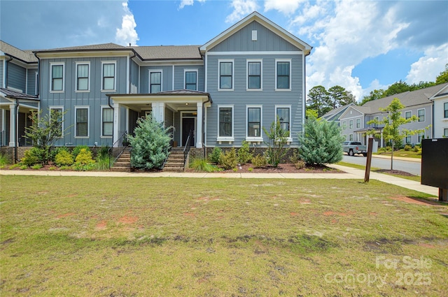 10149 Meeting House Dr NW, Huntersville, NC 28078 - townhome / multi-family property with board and batten siding, a front lawn, covered porch, and stairway
