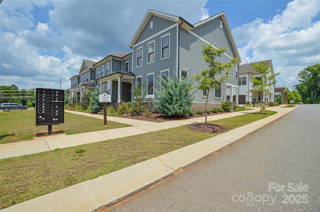 10149 Meeting House Dr NW, Huntersville, NC 28078 - view of property featuring board and batten siding, a front lawn, and a residential view