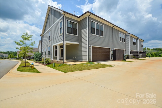 10149 Meeting House Dr NW, Huntersville, NC 28078 - view of property exterior featuring board and batten siding, a garage, and concrete driveway