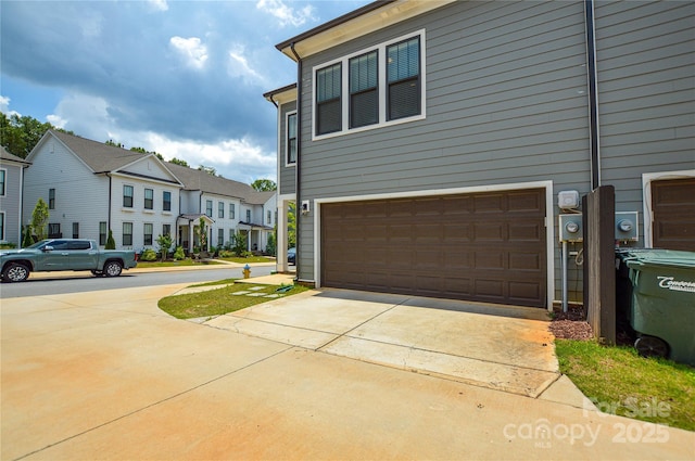 10149 Meeting House Dr NW, Huntersville, NC 28078 - view of side of property with a garage, a residential view, and concrete driveway