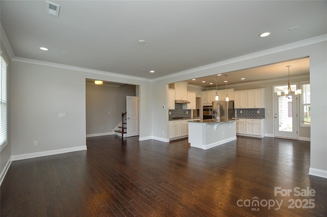 10149 Meeting House Dr NW, Huntersville, NC 28078 - unfurnished living room featuring a chandelier, crown molding, stairway, dark wood-type flooring, and recessed lighting