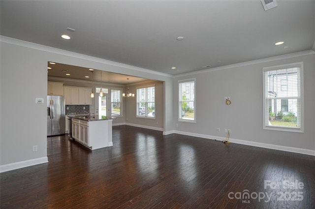 10149 Meeting House Dr NW, Huntersville, NC 28078 - unfurnished living room featuring ornamental molding, dark wood-type flooring, a chandelier, and recessed lighting