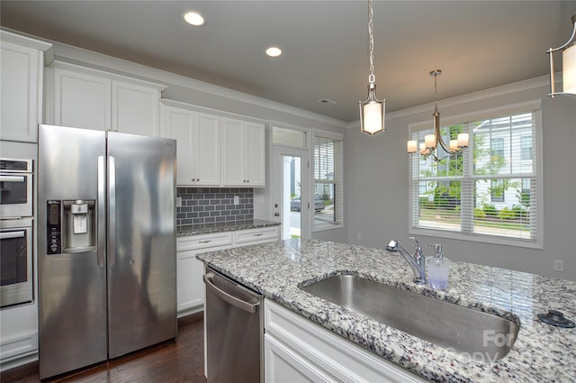 10149 Meeting House Dr NW, Huntersville, NC 28078 - kitchen with stainless steel appliances, dark wood-type flooring, a chandelier, decorative backsplash, and white cabinets