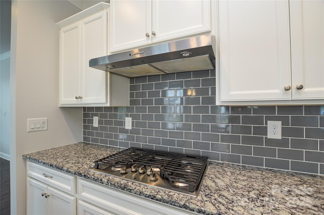 10149 Meeting House Dr NW, Huntersville, NC 28078 - kitchen featuring under cabinet range hood, stainless steel gas stovetop, white cabinets, and backsplash