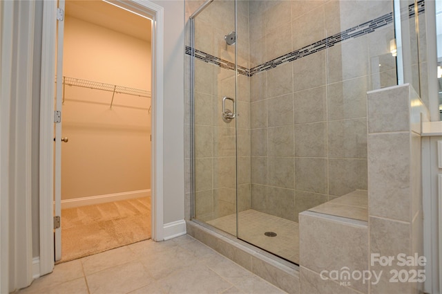 10149 Meeting House Dr NW, Huntersville, NC 28078 - bathroom with a shower stall, a walk in closet, and tile patterned flooring
