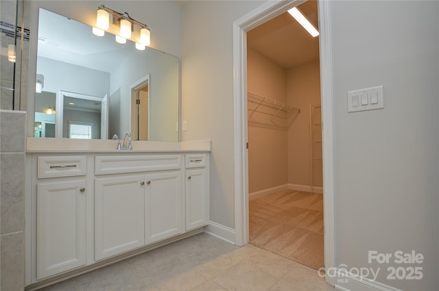 10149 Meeting House Dr NW, Huntersville, NC 28078 - bathroom featuring vanity, a walk in closet, and tile patterned floors
