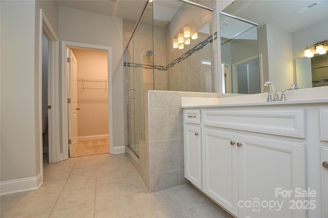 10149 Meeting House Dr NW, Huntersville, NC 28078 - bathroom with a shower stall, vanity, tile patterned floors, and a spacious closet
