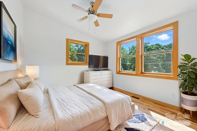 109 Azalea Ave, Swannanoa, NC 28778 - bedroom featuring multiple windows, wood finished floors, lofted ceiling, and ceiling fan