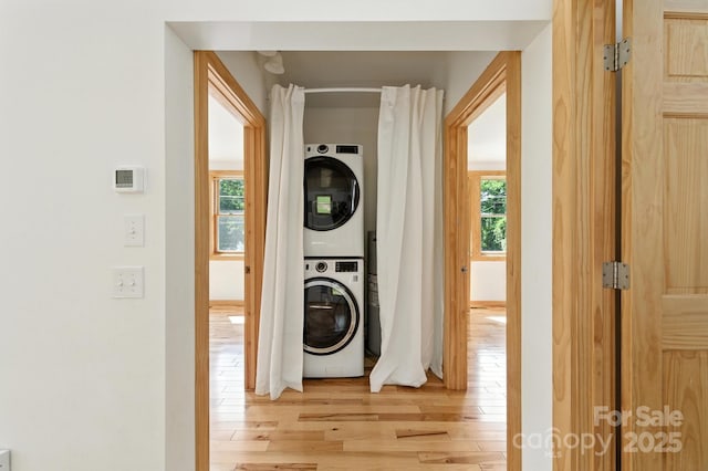 109 Azalea Ave, Swannanoa, NC 28778 - laundry room featuring stacked washer / drying machine, light wood-style flooring, and healthy amount of natural light