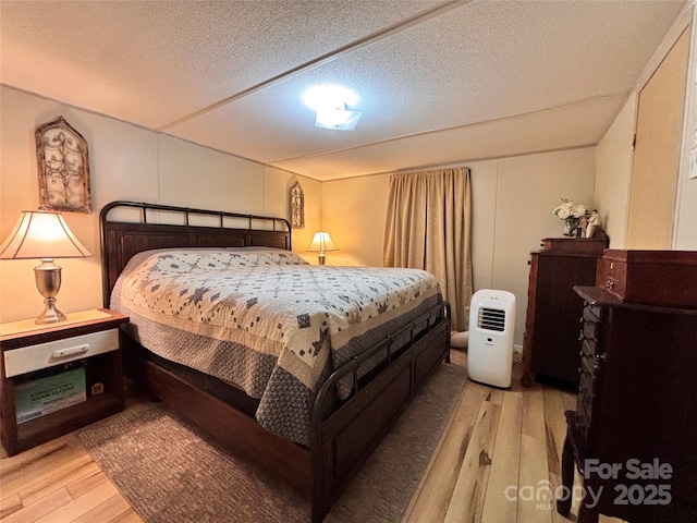 1890 Bud Tilley Rd, Pinnacle, NC 27043 - bedroom with light wood-style flooring and a textured ceiling